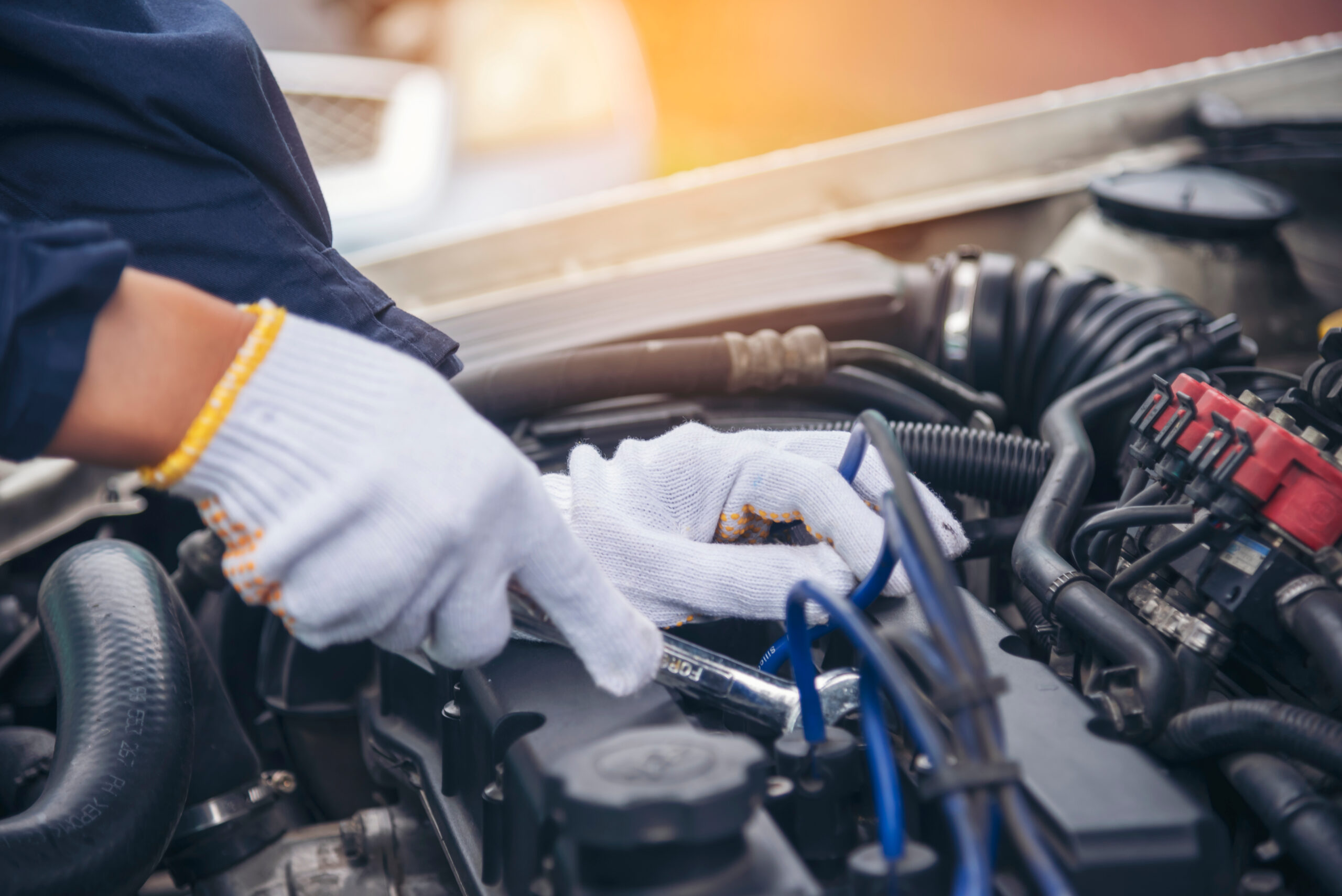 Man with tools for truck. Worker in uniform. Faulty truck