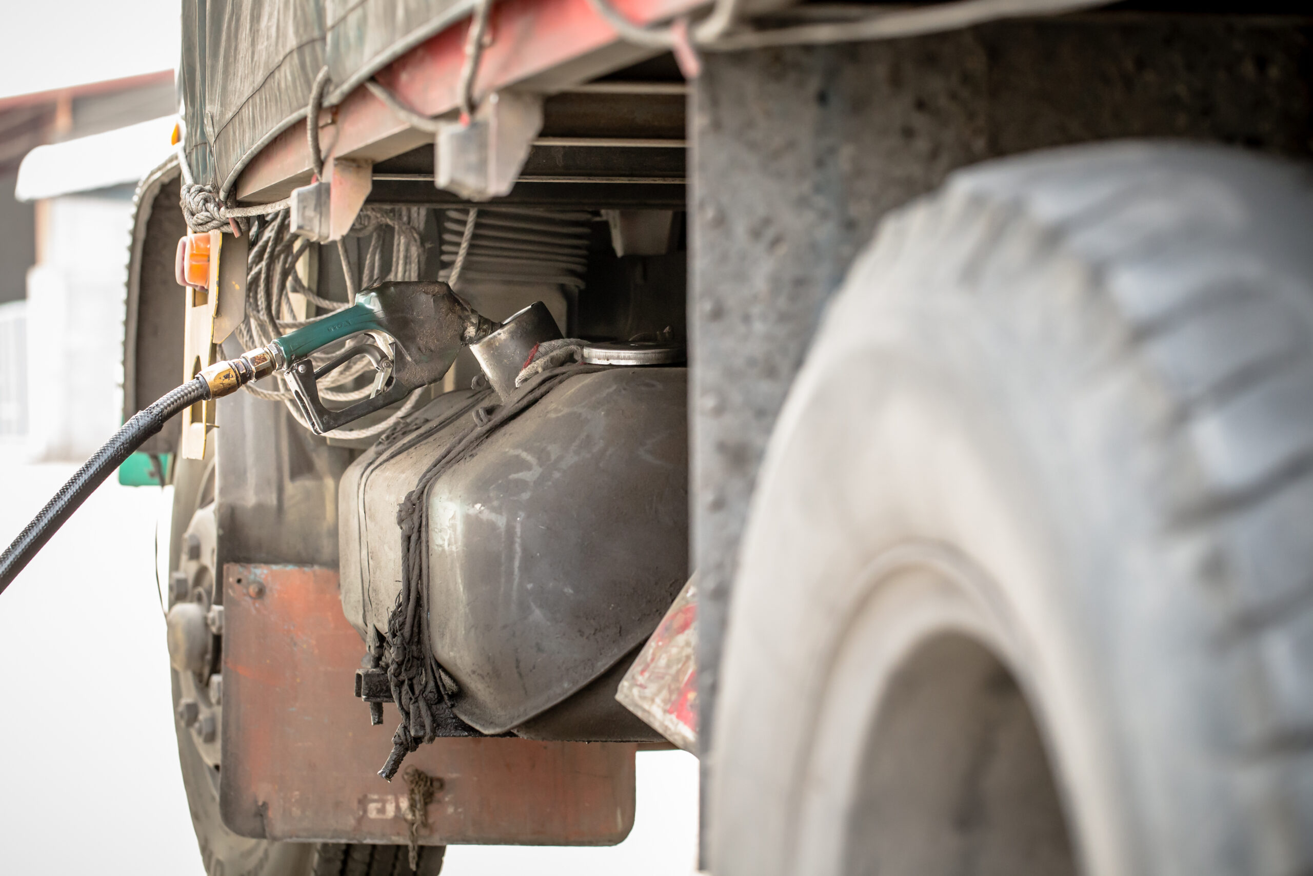 Man with tools for truck. Worker in uniform. Faulty truck