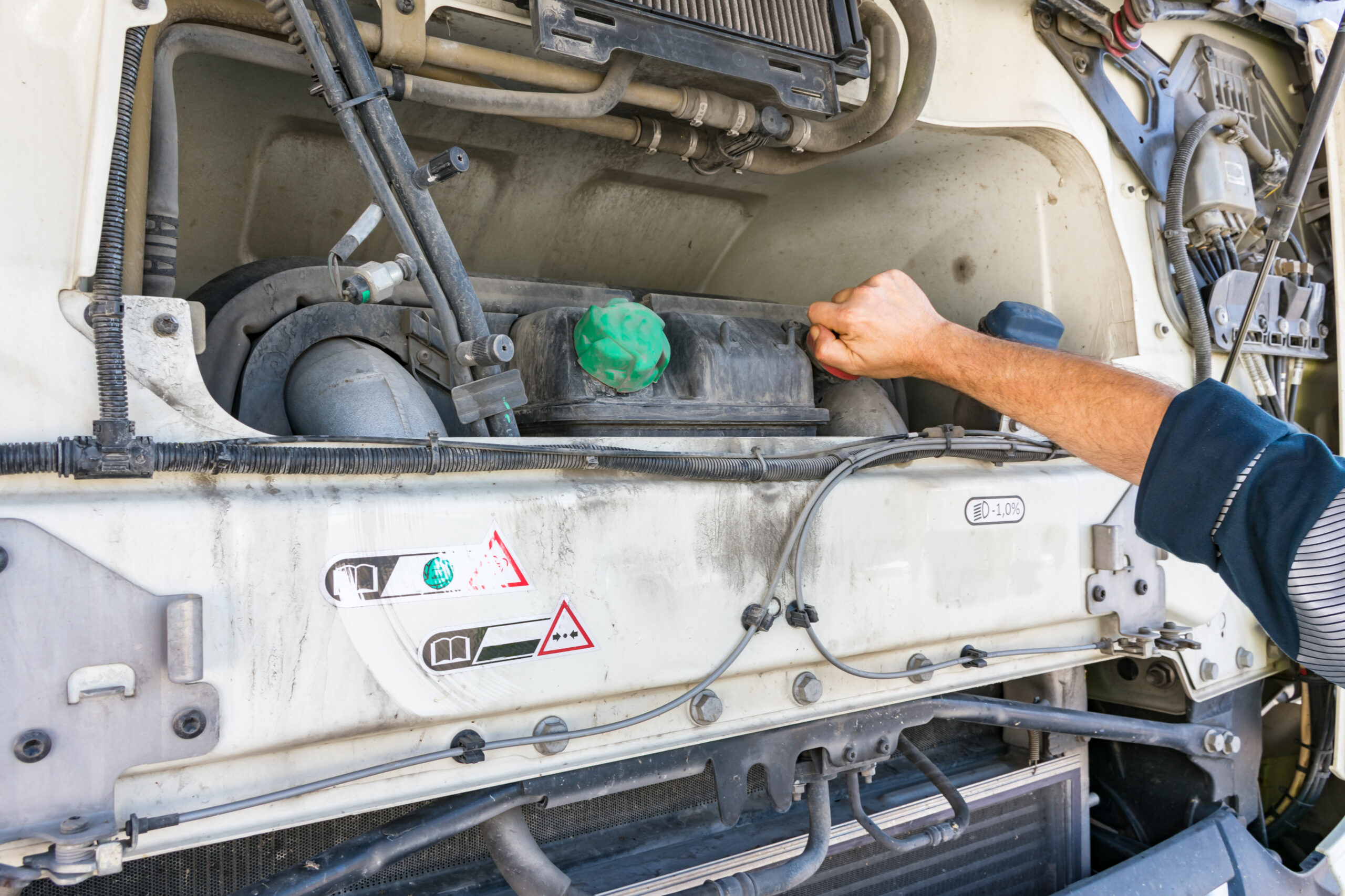 A mechanic inspects a heavy-duty diesel engine, a crucial step for passing the CARB Clean Truck Check